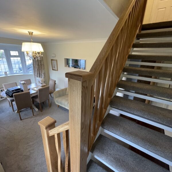 Open tread staircase renovation in Burbage featuring bespoke oak newel posts, modern twist metal spindles, and custom under-stair doors. A stylish upgrade completed in just two days by Robert McVey Staircases.